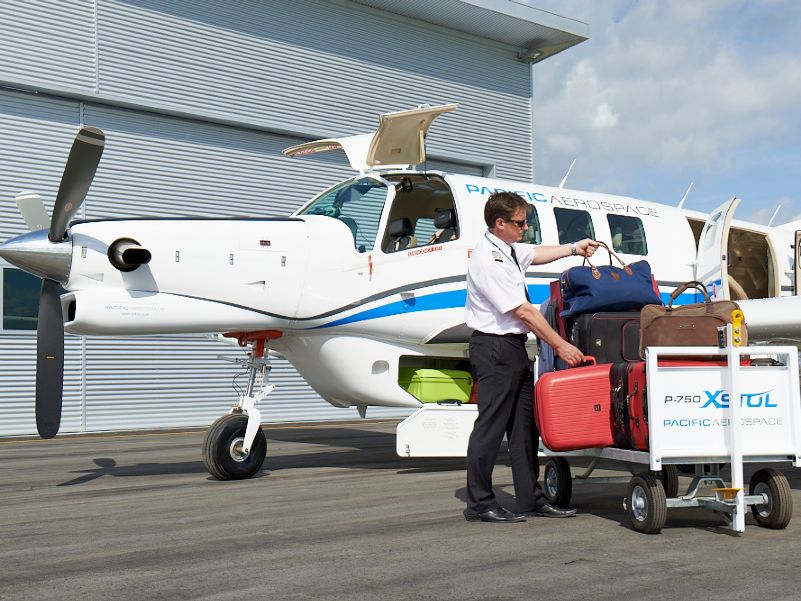 Pilot loading luggage